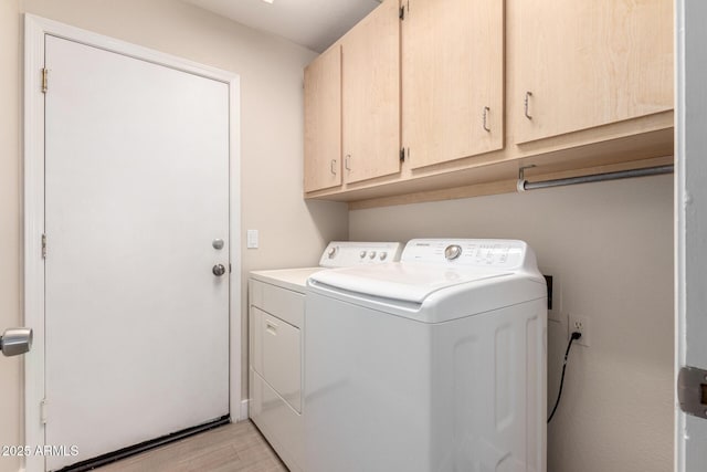 laundry area featuring cabinets and washing machine and dryer