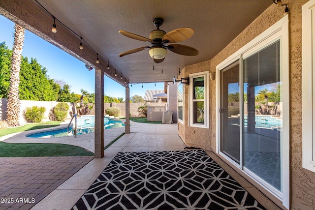 view of patio featuring ceiling fan and a fenced in pool