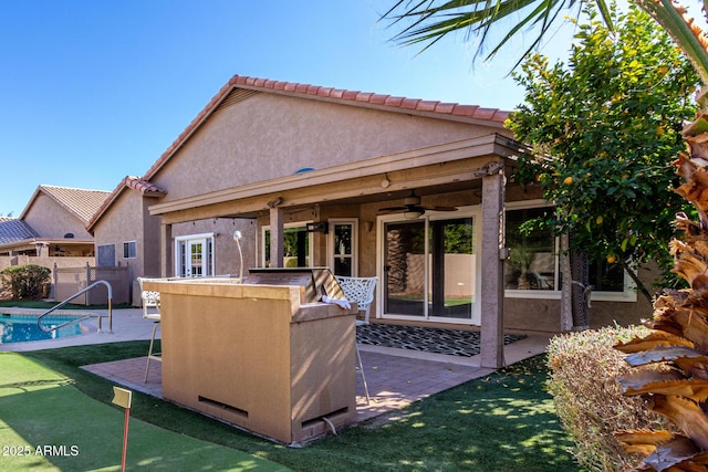 back of house featuring ceiling fan and a patio