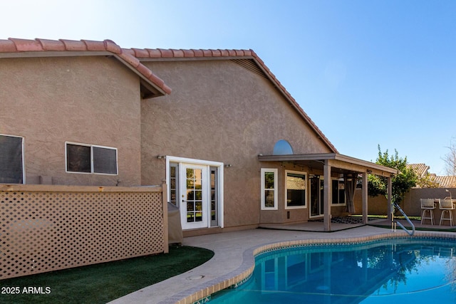 back of house featuring a fenced in pool and a patio area