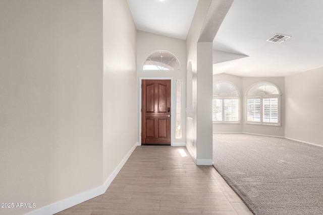 foyer entrance featuring light hardwood / wood-style floors and lofted ceiling