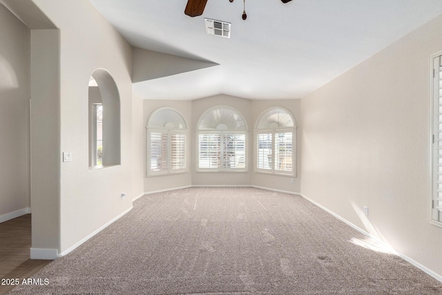 unfurnished room featuring carpet flooring, ceiling fan, and vaulted ceiling