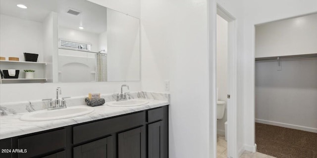 5549 E Mearn Rd, San Tan Valley, AZ 85140 - bathroom with toilet, double vanity, a spacious closet, baseboards, and recessed lighting