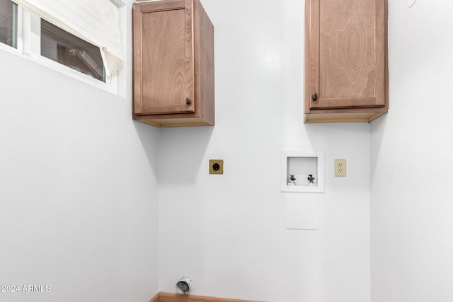 washroom featuring hookup for a washing machine, cabinets, and hookup for an electric dryer