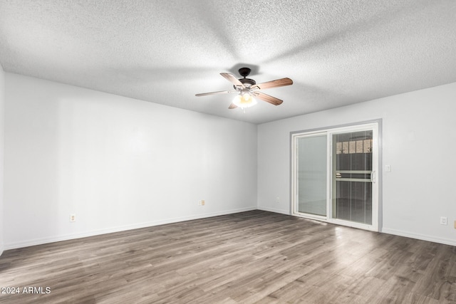 spare room with hardwood / wood-style floors, ceiling fan, and a textured ceiling