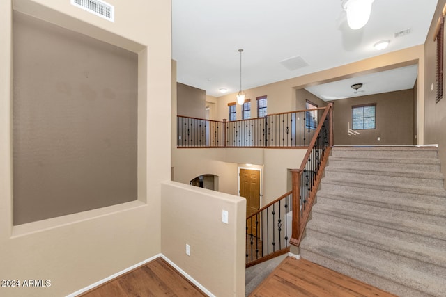 stairs featuring hardwood / wood-style floors