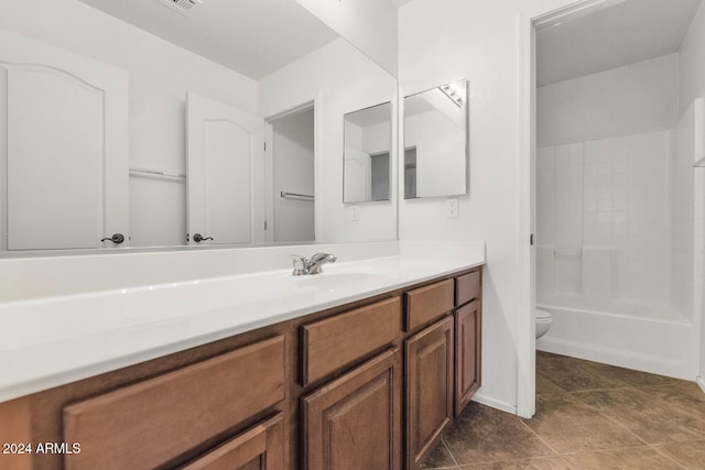 full bathroom featuring tile patterned floors, vanity, toilet, and shower / tub combination