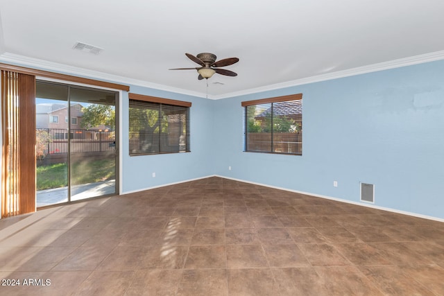 spare room featuring ceiling fan, crown molding, and a healthy amount of sunlight