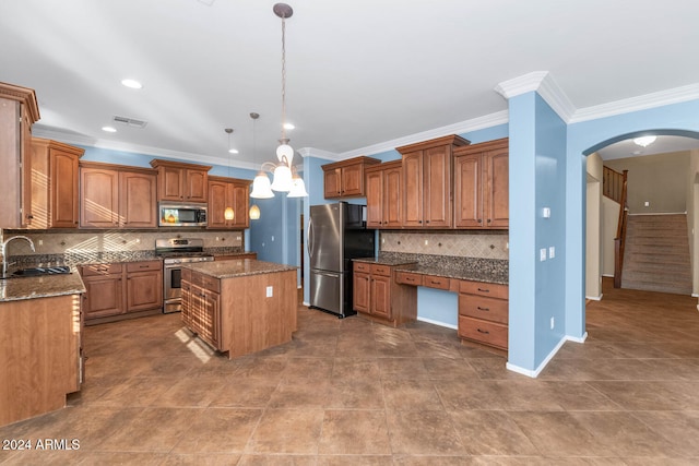 kitchen with dark stone countertops, sink, a kitchen island, and stainless steel appliances