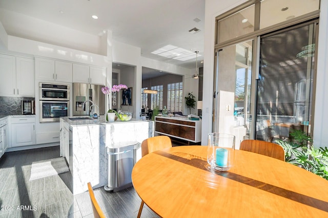 dining space featuring dark wood finished floors and visible vents