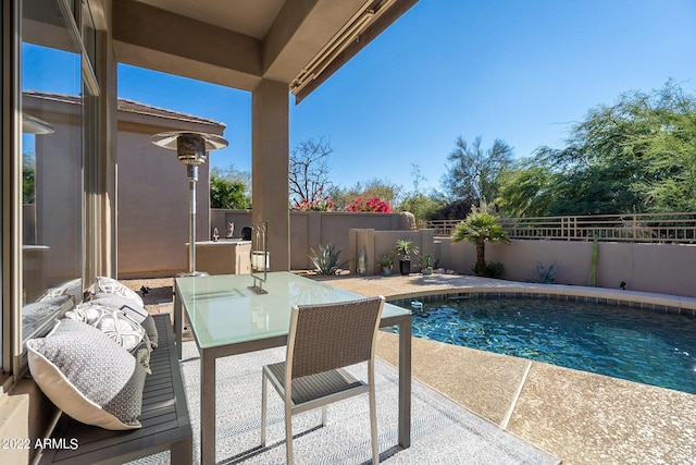 view of pool with a fenced backyard, a fenced in pool, outdoor dining space, and a patio area