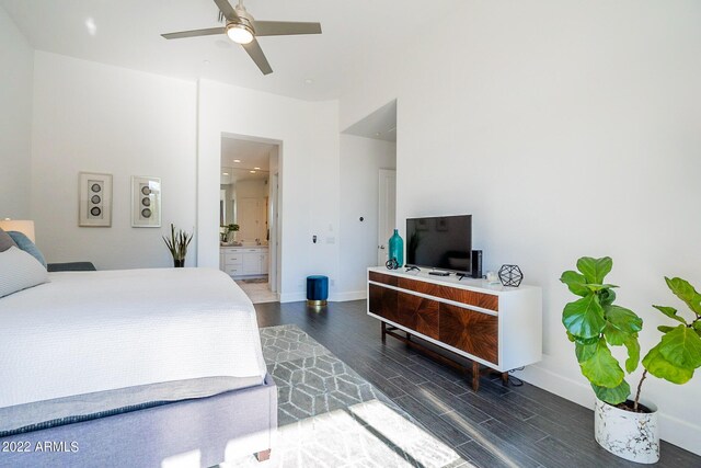 bedroom with baseboards, wood finished floors, ensuite bathroom, and a ceiling fan