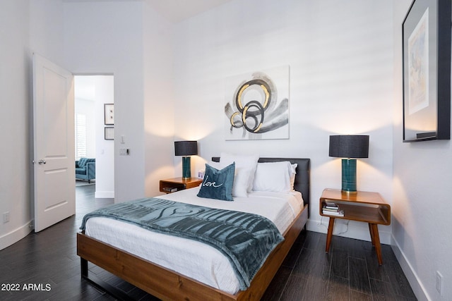 bedroom with baseboards and wood finished floors