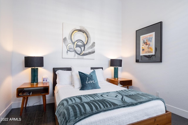 bedroom featuring baseboards and wood finished floors