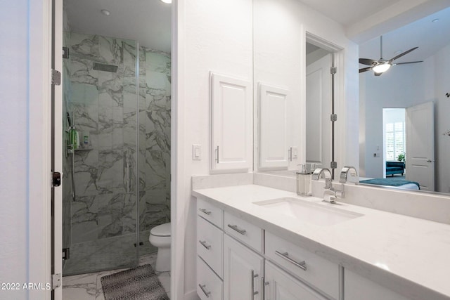 ensuite bathroom featuring marble finish floor, a marble finish shower, toilet, and vanity
