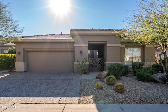 prairie-style home with stucco siding, an attached garage, and concrete driveway