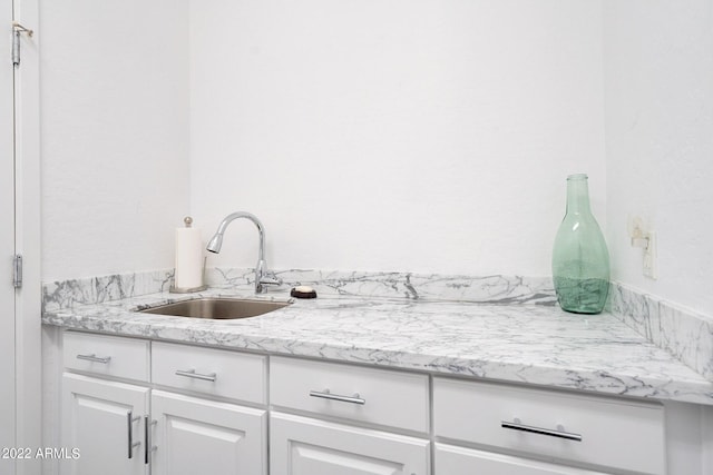 interior space with white cabinets and a sink