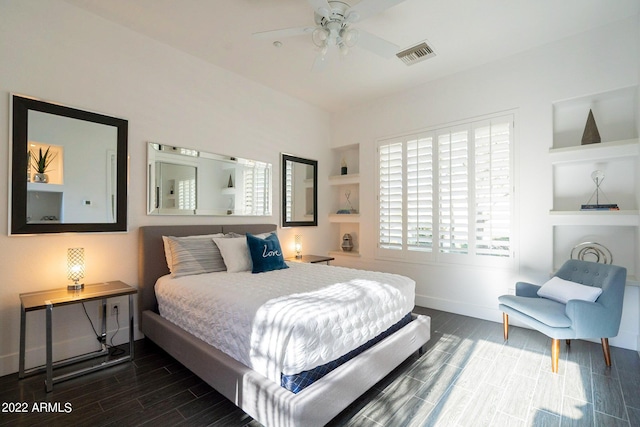 bedroom with a ceiling fan, wood tiled floor, baseboards, and visible vents