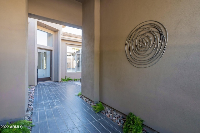 view of exterior entry featuring stucco siding