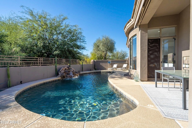 view of swimming pool with a patio, a fenced in pool, and a fenced backyard