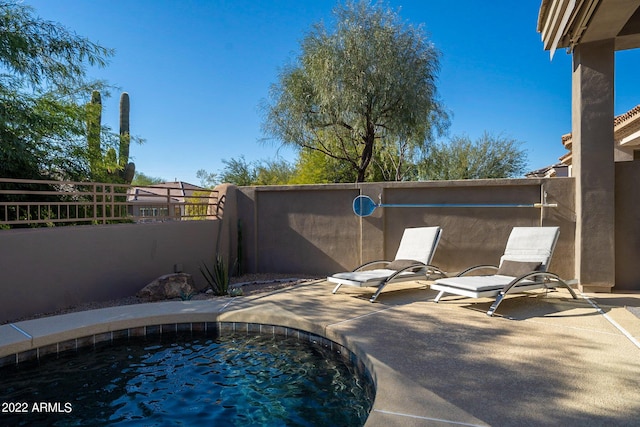 view of swimming pool with fence and a patio area
