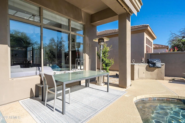 view of patio featuring a jacuzzi and outdoor dining space