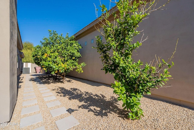 view of patio with central AC unit and fence