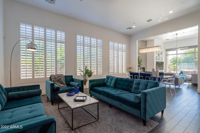 living area with visible vents, wood finished floors, and recessed lighting