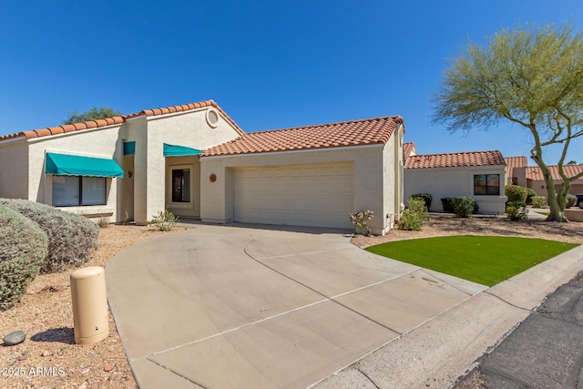 15087 N 86th Dr, Peoria, AZ 85381 - mediterranean / spanish home featuring a tiled roof, concrete driveway, stucco siding, and an attached garage