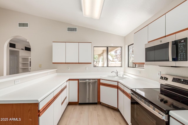15087 N 86th Dr, Peoria, AZ 85381 - kitchen with visible vents, lofted ceiling, a sink, and stainless steel appliances