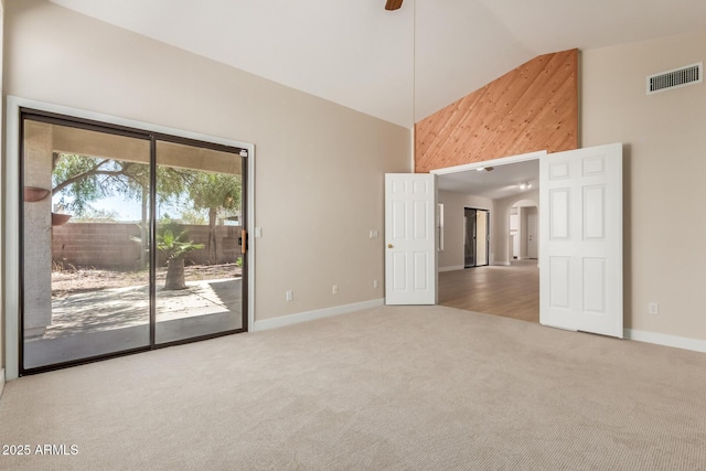 15087 N 86th Dr, Peoria, AZ 85381 - carpeted empty room with high vaulted ceiling, baseboards, arched walkways, ceiling fan, and visible vents