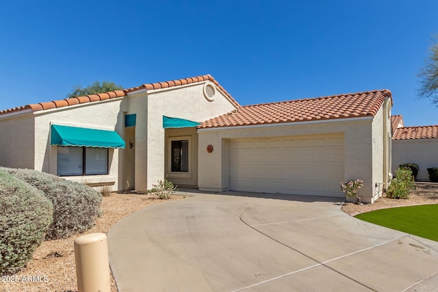 15087 N 86th Dr, Peoria, AZ 85381 - mediterranean / spanish-style home with a tile roof, stucco siding, an attached garage, and driveway