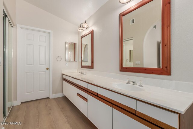 15087 N 86th Dr, Peoria, AZ 85381 - full bath with double vanity, a sink, lofted ceiling, and wood finished floors