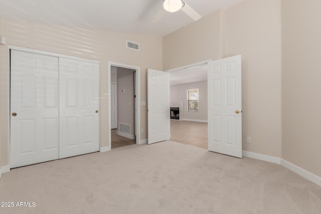 15087 N 86th Dr, Peoria, AZ 85381 - unfurnished bedroom featuring carpet flooring, a fireplace, vaulted ceiling, and visible vents