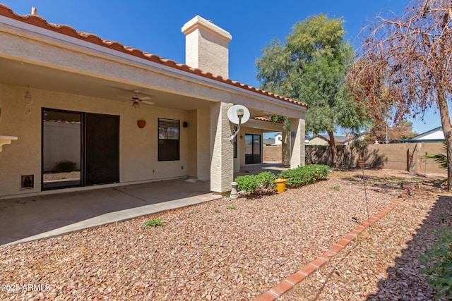 15087 N 86th Dr, Peoria, AZ 85381 - rear view of house featuring a patio area, a chimney, stucco siding, fence, and ceiling fan