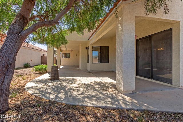 15087 N 86th Dr, Peoria, AZ 85381 - rear view of house with stucco siding, fence, and a patio area