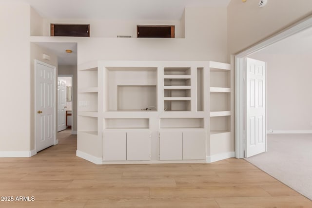 15087 N 86th Dr, Peoria, AZ 85381 - unfurnished bedroom featuring baseboards, a towering ceiling, visible vents, and light wood finished floors