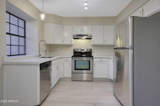 kitchen featuring pendant lighting, sink, white cabinets, and appliances with stainless steel finishes