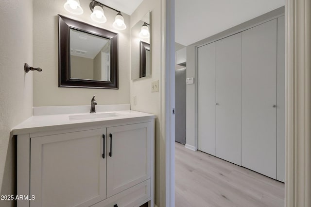 bathroom featuring vanity and hardwood / wood-style floors