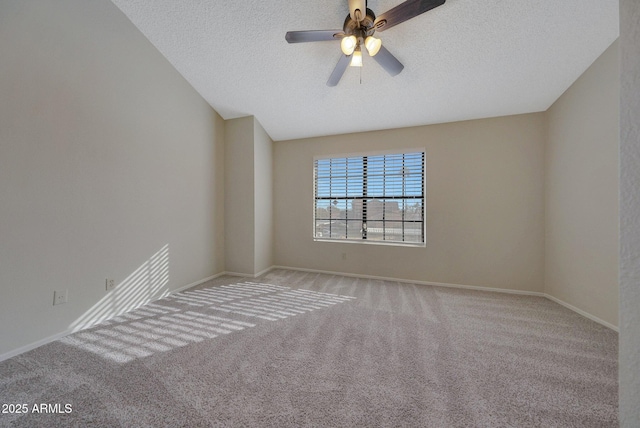 unfurnished room with ceiling fan, light carpet, and a textured ceiling