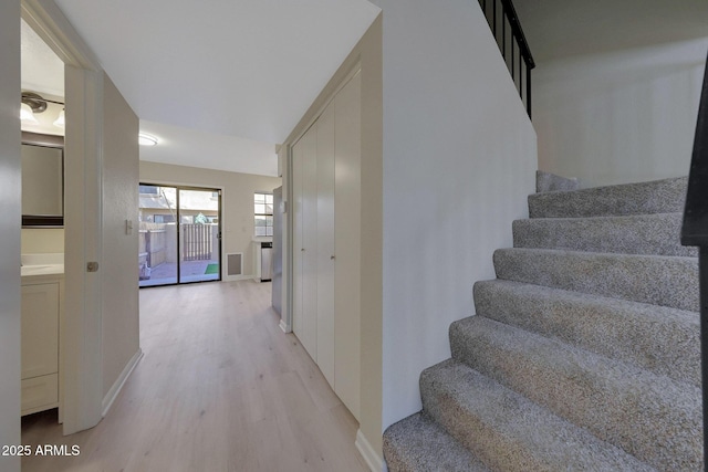 stairs featuring hardwood / wood-style flooring