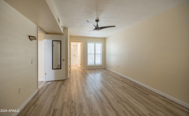 empty room with light hardwood / wood-style flooring and ceiling fan