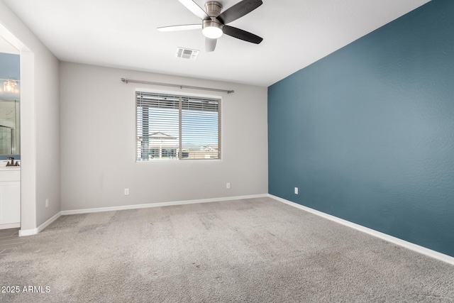 unfurnished room with ceiling fan and carpet flooring