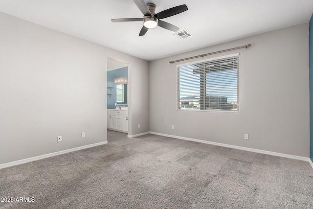 carpeted spare room featuring ceiling fan