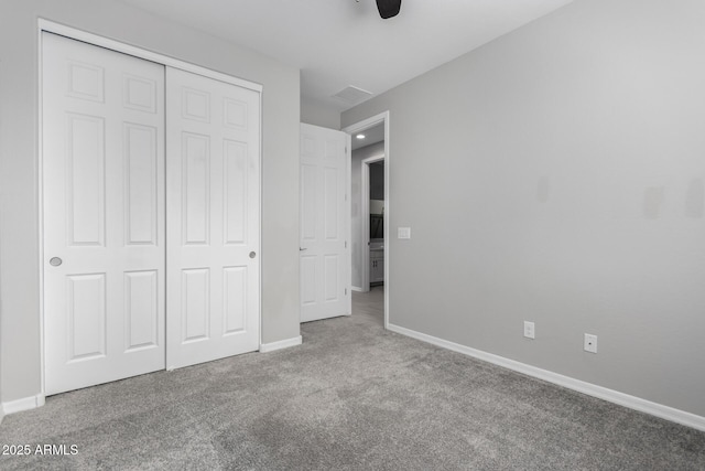 unfurnished bedroom with light colored carpet, ceiling fan, and a closet