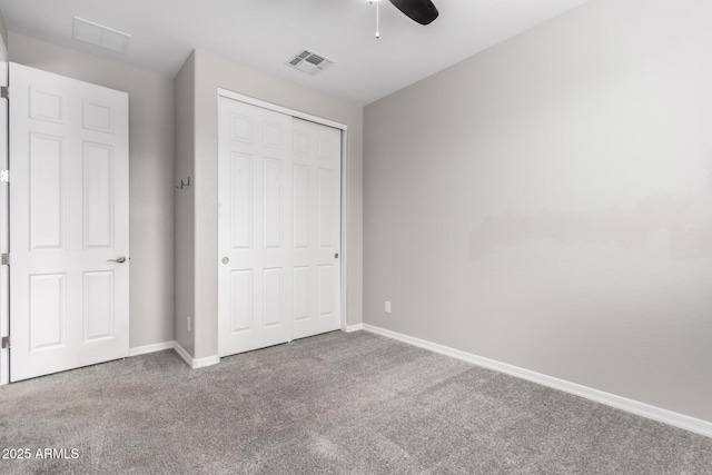 unfurnished bedroom with ceiling fan, carpet floors, and a closet