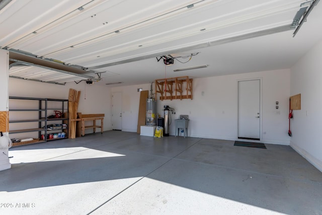 garage featuring a garage door opener, gas water heater, and sink