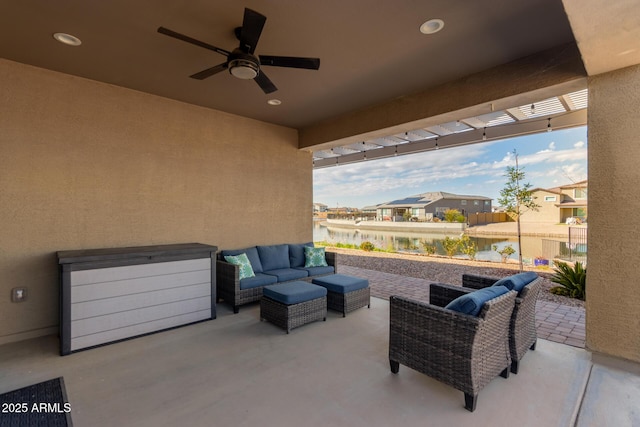 view of patio / terrace with a water view, an outdoor hangout area, and ceiling fan