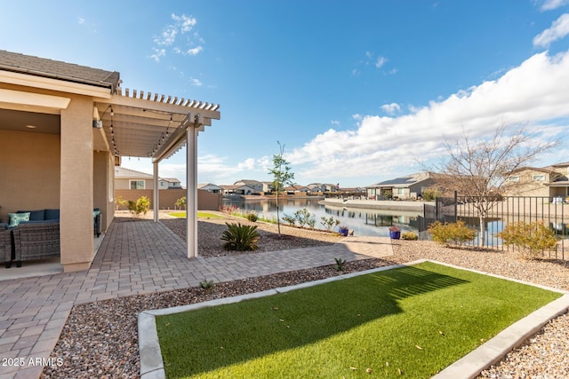 view of yard with a water view, a pergola, and a patio area