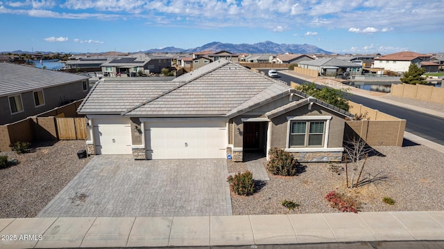 ranch-style house featuring a garage and a mountain view